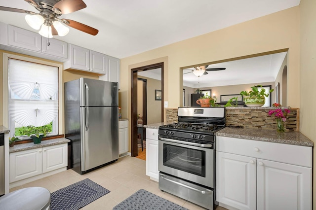 1100 Summit Ave, Saint Paul Park, MN 55071 - kitchen with appliances with stainless steel finishes, ceiling fan, backsplash, white cabinets, and light tile patterned flooring