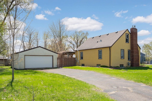 1100 Summit Ave, Saint Paul Park, MN 55071 - view of side of home with an outdoor structure, a garage, a chimney, and stucco siding