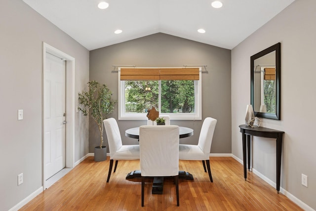 dining space featuring recessed lighting, baseboards, wood finished floors, and vaulted ceiling