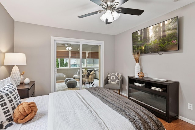 bedroom featuring baseboards, ceiling fan, and wood finished floors