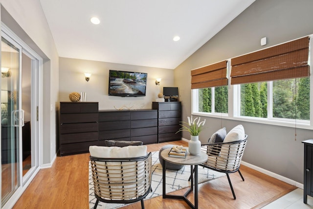 interior space featuring baseboards, recessed lighting, light wood finished floors, and vaulted ceiling
