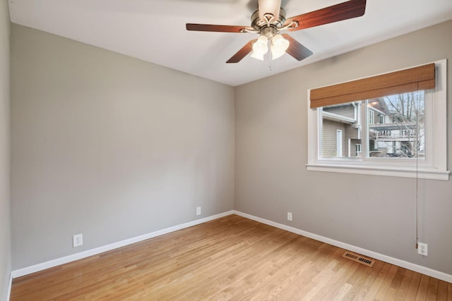 spare room featuring visible vents, baseboards, ceiling fan, and light wood-type flooring