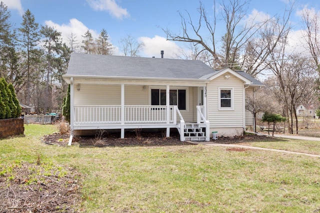 view of front of house featuring covered porch and a front lawn