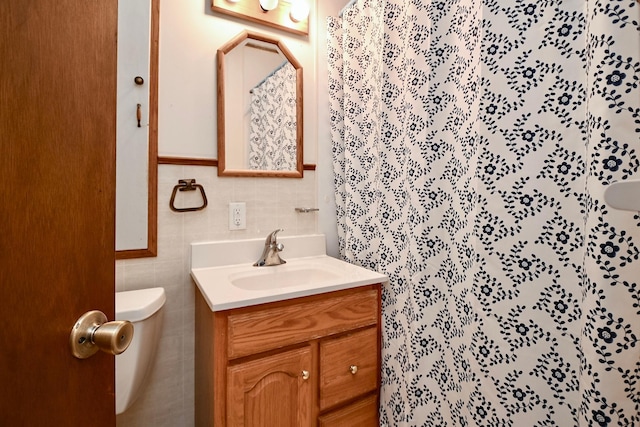 full bath featuring vanity, curtained shower, toilet, and tile walls