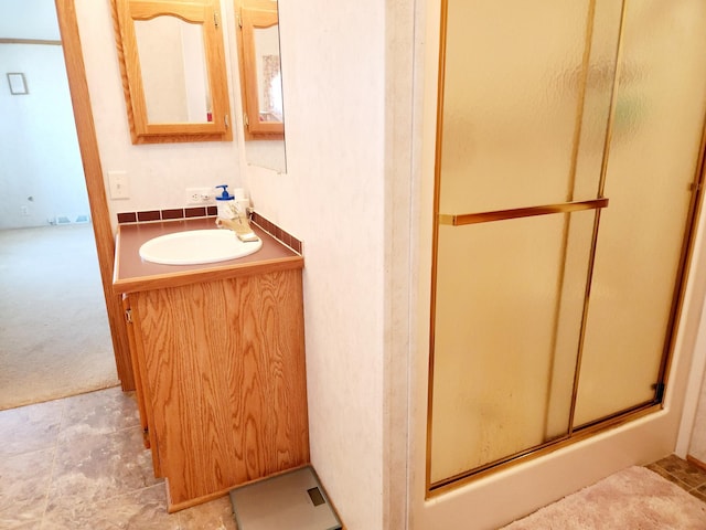 bathroom with vanity and a shower stall