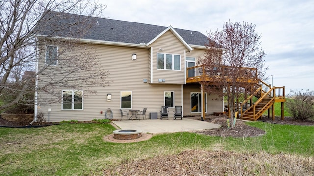 back of property featuring a fire pit, a wooden deck, a patio area, a yard, and stairway