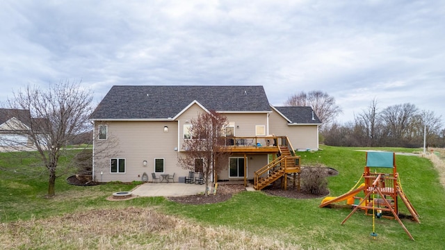 rear view of house with a wooden deck, stairway, a playground, a yard, and a patio