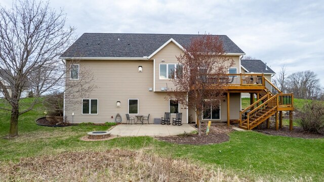 back of house with a lawn, stairs, an outdoor fire pit, and a wooden deck