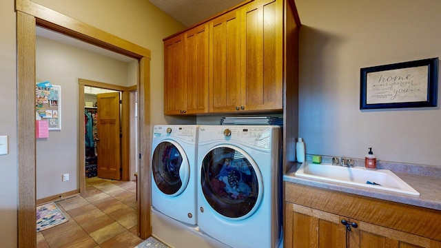 laundry area with a sink, cabinet space, and washer and dryer