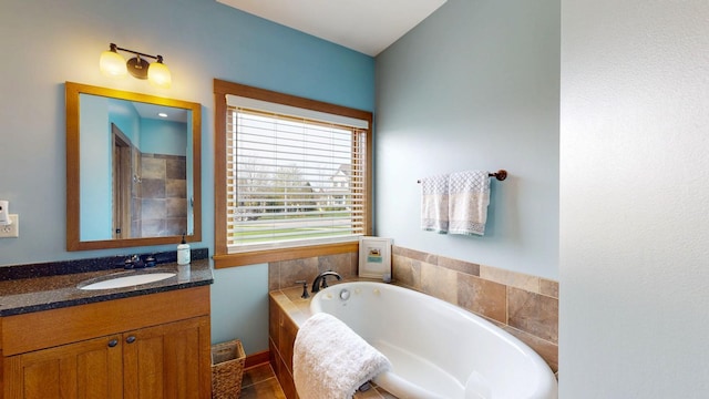 bathroom with vanity and a tub to relax in