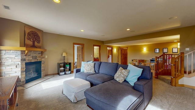 living room featuring stairway, visible vents, and light colored carpet