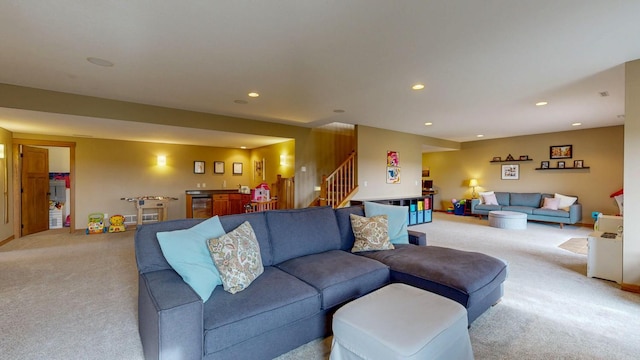 carpeted living room featuring recessed lighting, stairs, and bar area