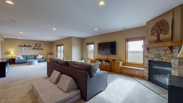 living room with light colored carpet, recessed lighting, and a fireplace