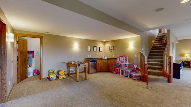playroom featuring light colored carpet, recessed lighting, and indoor bar