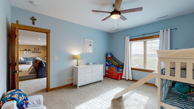 bedroom with carpet flooring, a ceiling fan, baseboards, and visible vents