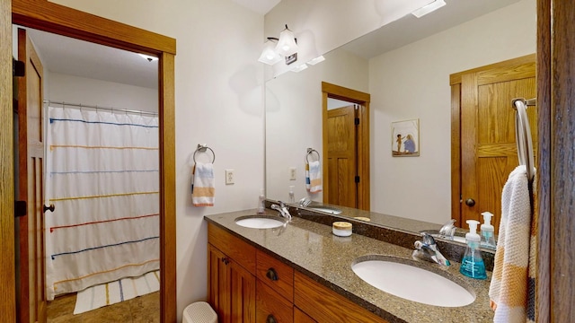 bathroom with a sink and double vanity