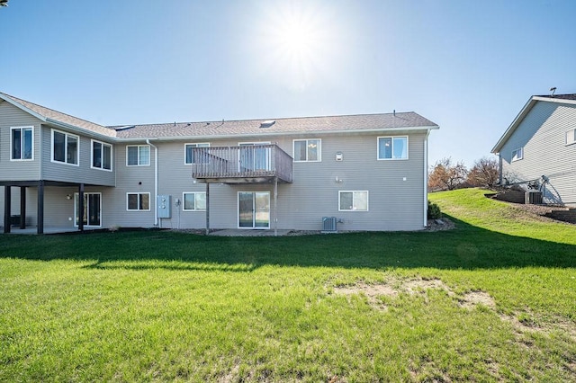 back of property with a lawn, a deck, and central AC unit