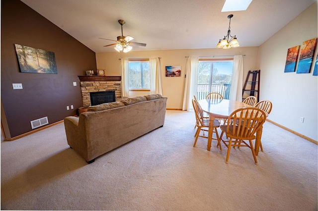 living room with baseboards, light carpet, vaulted ceiling, and visible vents
