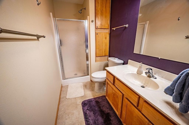 bathroom featuring vanity, toilet, baseboards, and a stall shower