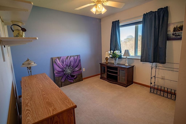 carpeted office featuring baseboards, visible vents, and ceiling fan