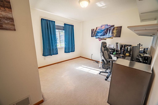 carpeted home office featuring baseboards