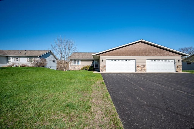 ranch-style home with a detached garage, a front yard, and stone siding