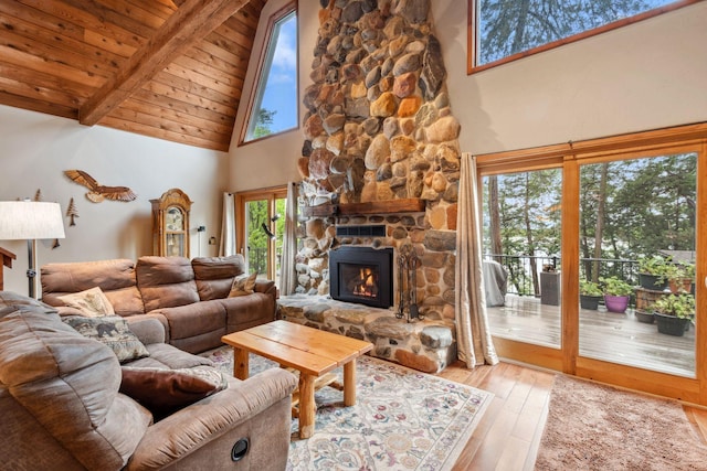 25020 Cedar Lake Dr, New Prague, MN 56071 - living area with high vaulted ceiling, wood-type flooring, a fireplace, and a wooden ceiling with exposed beams