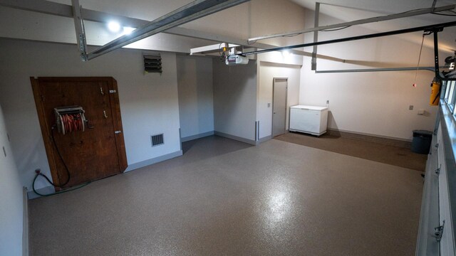 35873 Drumbeater Rd, Cohasset, MN 55721 - garage with fridge, a garage door opener, and baseboards