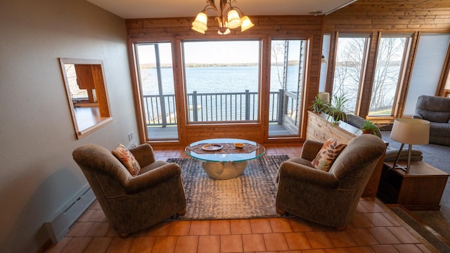 35873 Drumbeater Rd, Cohasset, MN 55721 - living area with a water view, a chandelier, baseboards, and wood walls