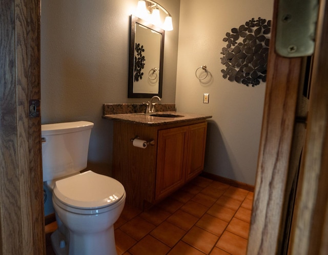 35873 Drumbeater Rd, Cohasset, MN 55721 - bathroom featuring toilet, vanity, tile patterned floors, and baseboards