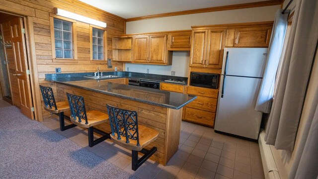 35873 Drumbeater Rd, Cohasset, MN 55721 - kitchen with freestanding refrigerator, black microwave, a sink, a breakfast bar, and open shelves