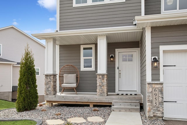 entrance to property featuring a porch and stone siding