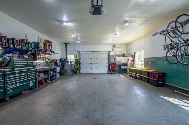 garage with a workshop area and a garage door opener