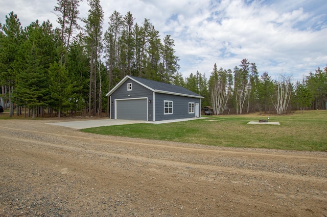 detached garage with concrete driveway