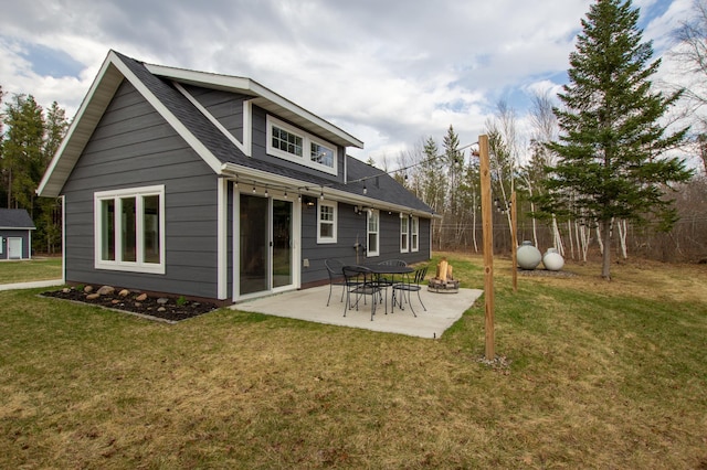 rear view of property with a patio, a shingled roof, a lawn, and fence