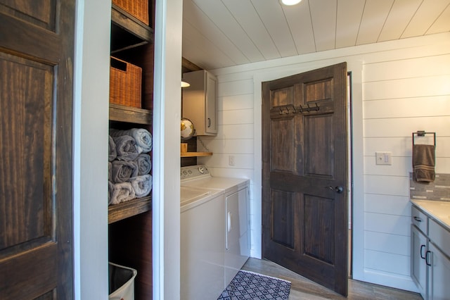 29133 Neighborly Dr, Laporte, MN 56461 - laundry room with cabinet space, separate washer and dryer, wooden walls, and dark wood-type flooring
