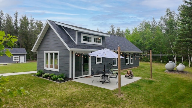 29133 Neighborly Dr, Laporte, MN 56461 - rear view of house featuring a patio area, a lawn, and roof with shingles
