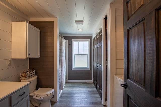 29133 Neighborly Dr, Laporte, MN 56461 - full bathroom featuring wood finished floors, vanity, wood walls, and a shower with shower curtain