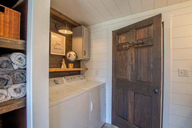 29133 Neighborly Dr, Laporte, MN 56461 - laundry room featuring washer and dryer, wooden walls, and cabinet space
