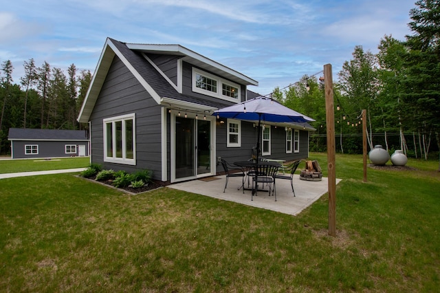 29133 Neighborly Dr, Laporte, MN 56461 - rear view of property with a lawn, a patio area, and an outdoor fire pit