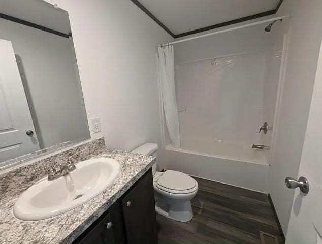 133 Maple Dr, Mankato, MN 56001 - bathroom with toilet, shower / bathtub combination with curtain, wood finished floors, and vanity