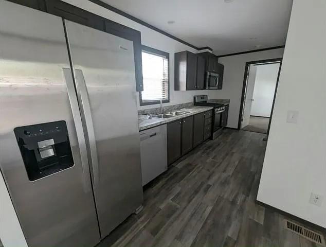 133 Maple Dr, Mankato, MN 56001 - kitchen with visible vents, light countertops, a sink, dark wood finished floors, and appliances with stainless steel finishes