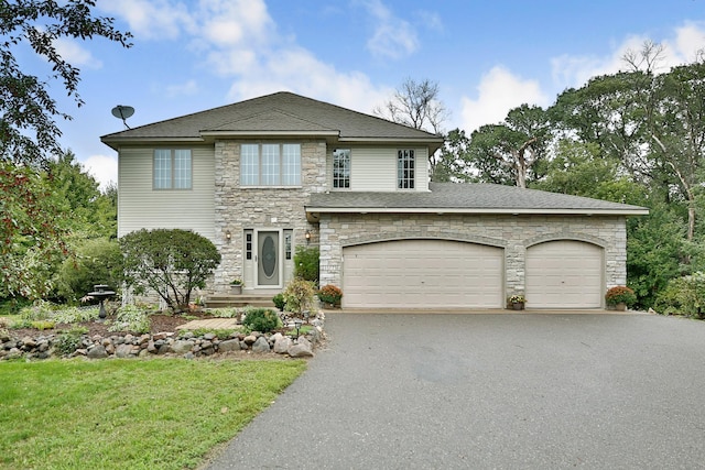 view of front facade with a front yard, driveway, and stone siding