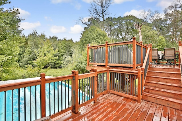 deck featuring a swimming pool