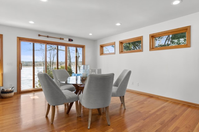 dining room with recessed lighting, light wood-type flooring, and baseboards