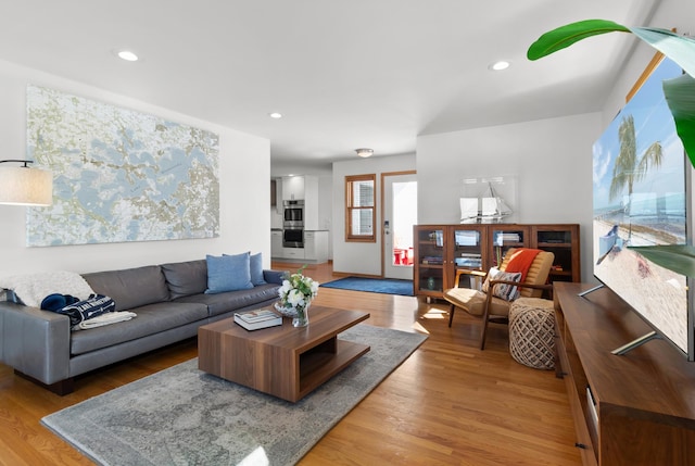living area featuring light wood-style floors and recessed lighting