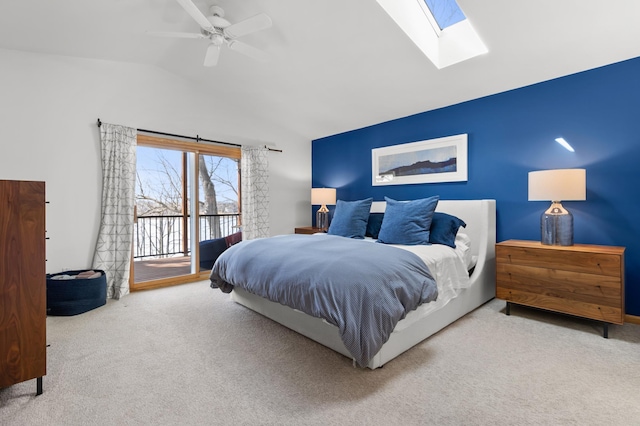bedroom featuring access to exterior, carpet, a skylight, vaulted ceiling, and ceiling fan