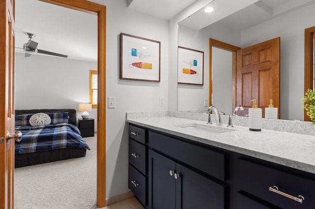 bathroom featuring ceiling fan, vanity, and baseboards