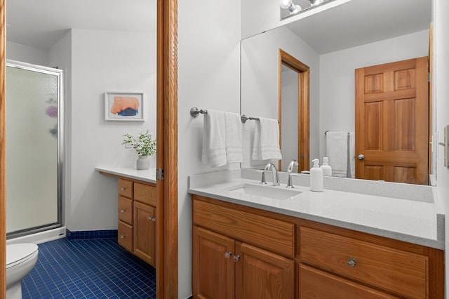 bathroom featuring vanity, a stall shower, tile patterned floors, and toilet