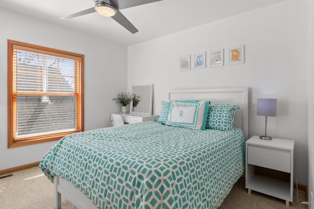 carpeted bedroom with baseboards and a ceiling fan
